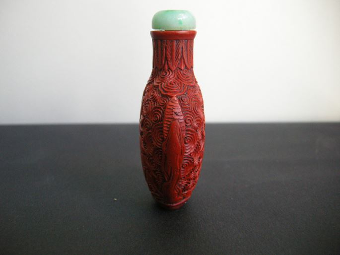 Cinnabar lacque snuff bottle on metal decorated and sculpted with a rider on one side and characters on a trolley on the other | MasterArt